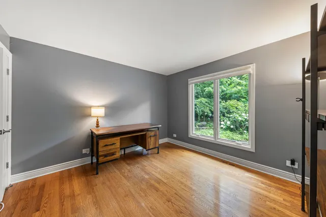a view of room with window and wooden floor