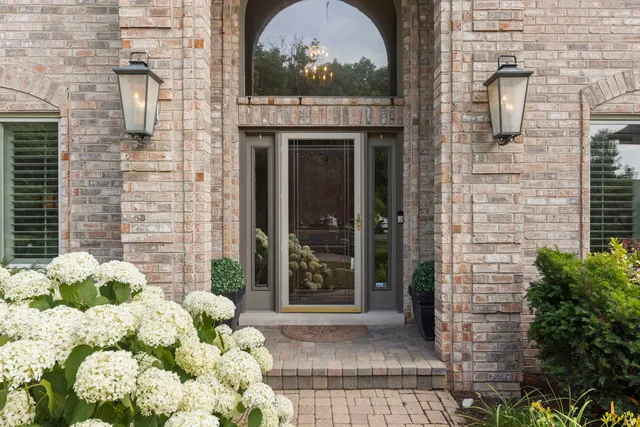 a front view of a house with a garden