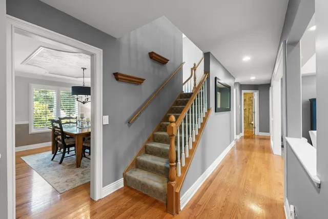 a view of a hallway view with wooden floor and staircase