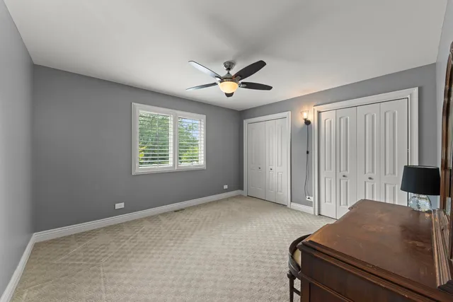 a living room with furniture and a ceiling fan