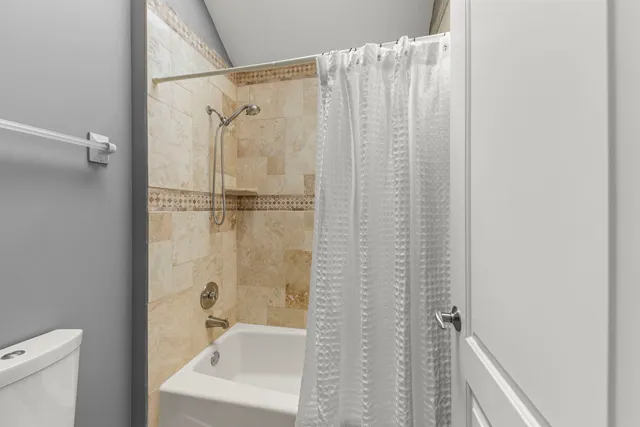 a bathroom with a shower and a sink