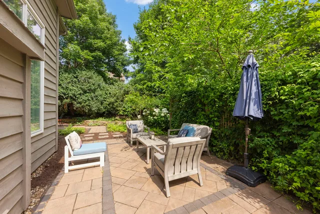 a view of a chairs and table in backyard