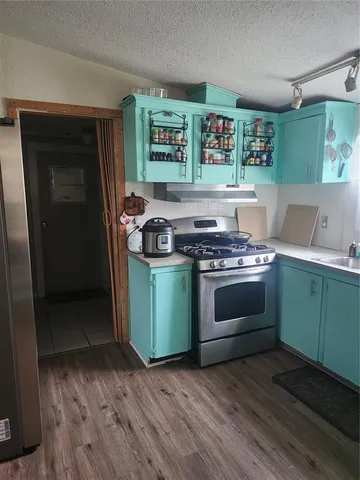 a kitchen with a stove and a refrigerator