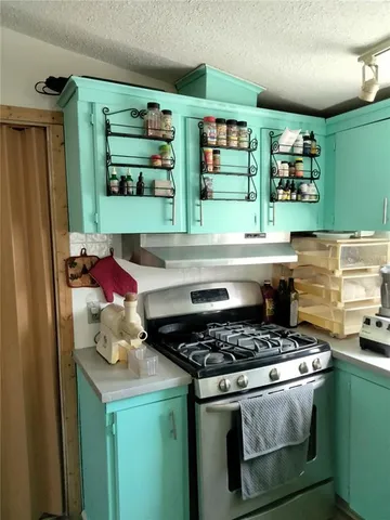 a kitchen with stainless steel appliances granite countertop a stove and a refrigerator
