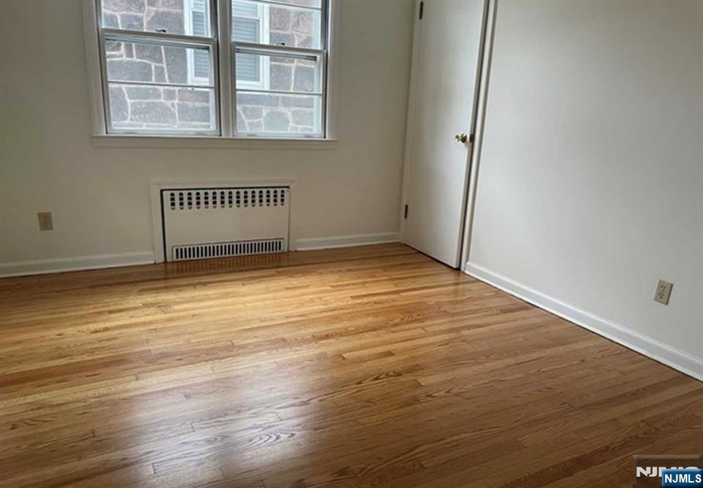 602 Studio Road Ridgefield, NJ 07657 - Photo 7 of 10 a view of a room with wooden floor and a window