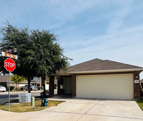 a view of a street with potted plants