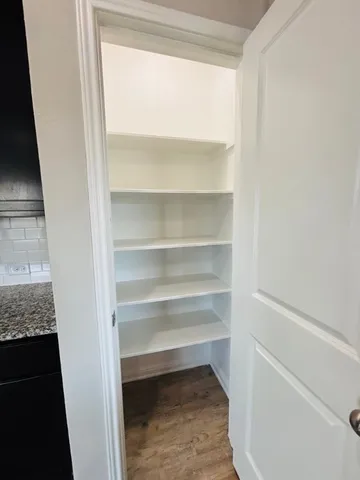 a large kitchen with a large counter top appliances and cabinets