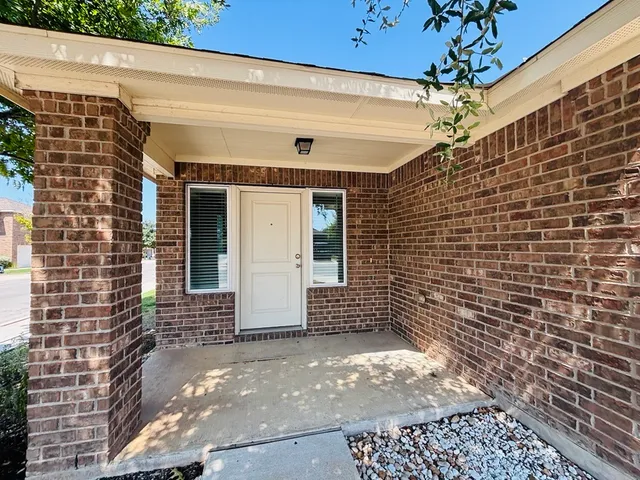 a view of a brick house with a door