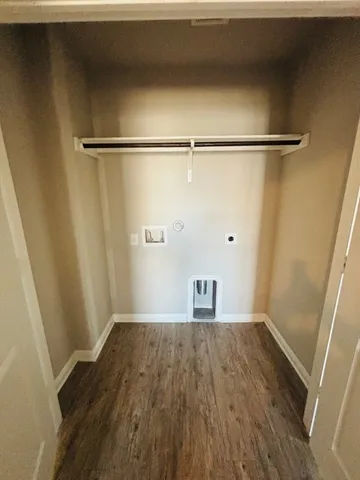 a view of a room with wooden floor and a window
