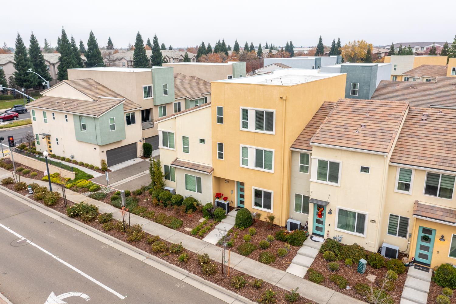 a view of a white building among the street and tall buildings