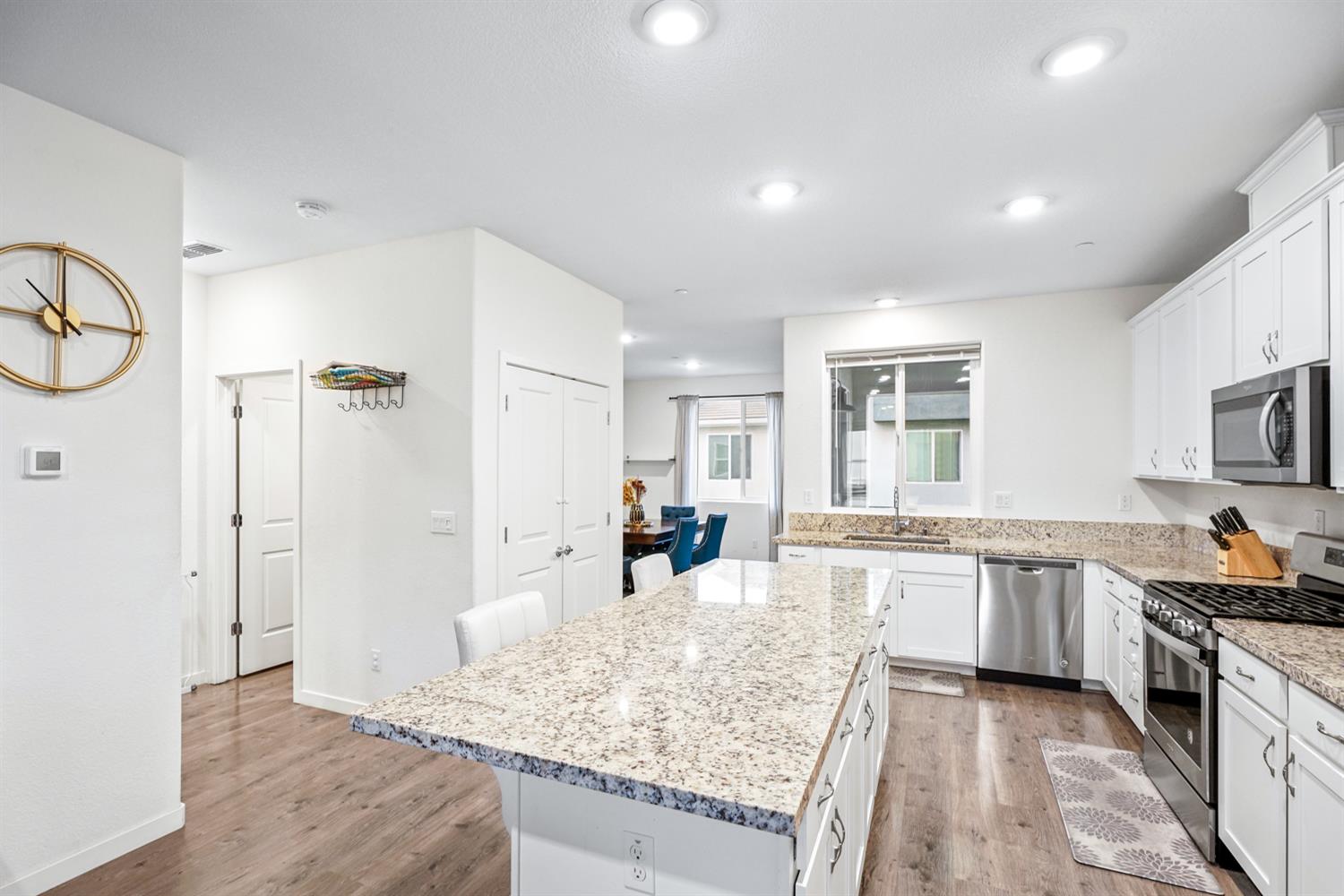 4174 Sally Ride Way Sacramento, CA 95834 - Photo 17 of 38 a kitchen with stainless steel appliances granite countertop a sink stove and refrigerator
