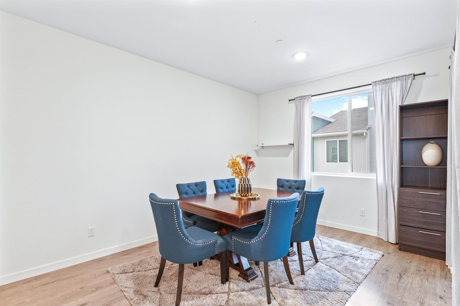 4174 Sally Ride Way Sacramento, CA 95834 - Photo 19 of 38 a dining room with furniture and window