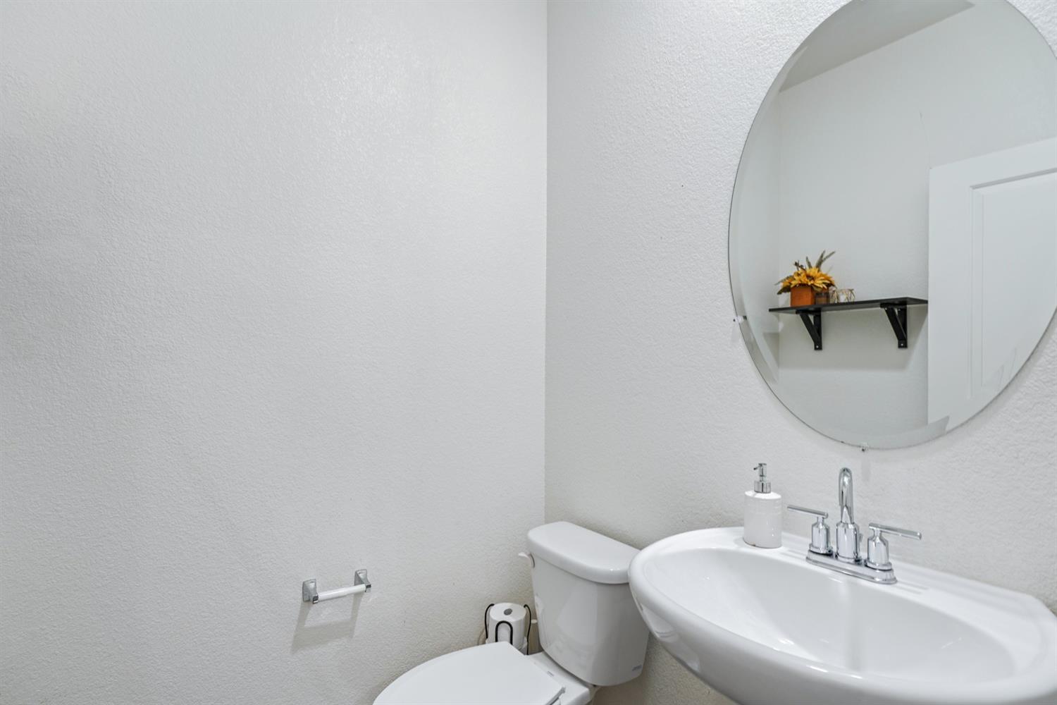 4174 Sally Ride Way Sacramento, CA 95834 - Photo 22 of 38 a bathroom with a toilet sink and mirror