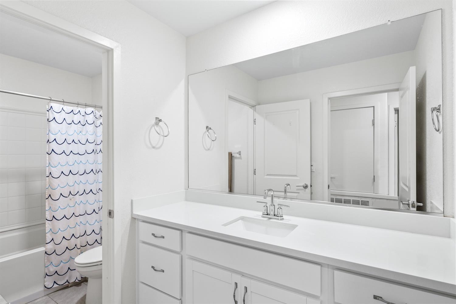 4174 Sally Ride Way Sacramento, CA 95834 - Photo 24 of 38 a bathroom with a sink and a mirror