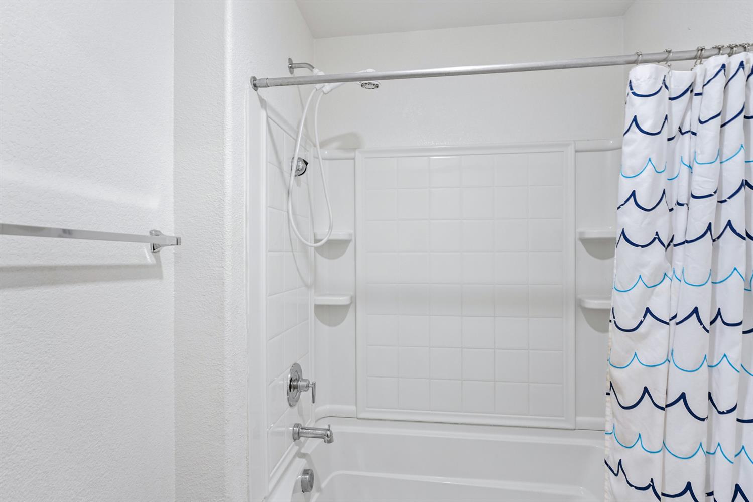 4174 Sally Ride Way Sacramento, CA 95834 - Photo 25 of 38 a bathroom with a shower and a shower curtain