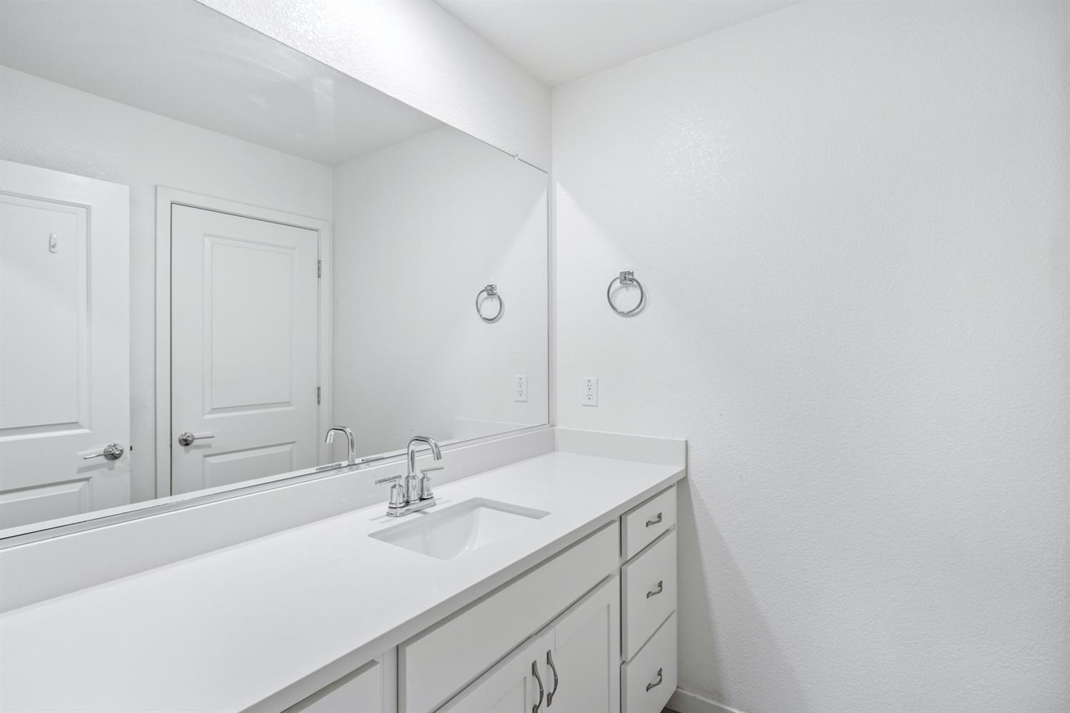 4174 Sally Ride Way Sacramento, CA 95834 - Photo 26 of 38 a bathroom with a sink and a mirror