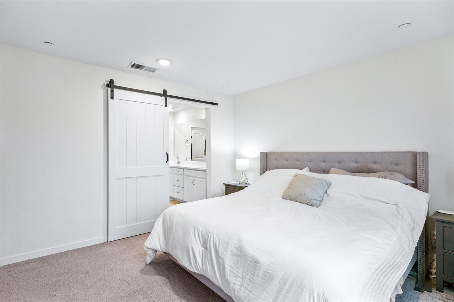 4174 Sally Ride Way Sacramento, CA 95834 - Photo 28 of 38 a bedroom with a bed and a refrigerator