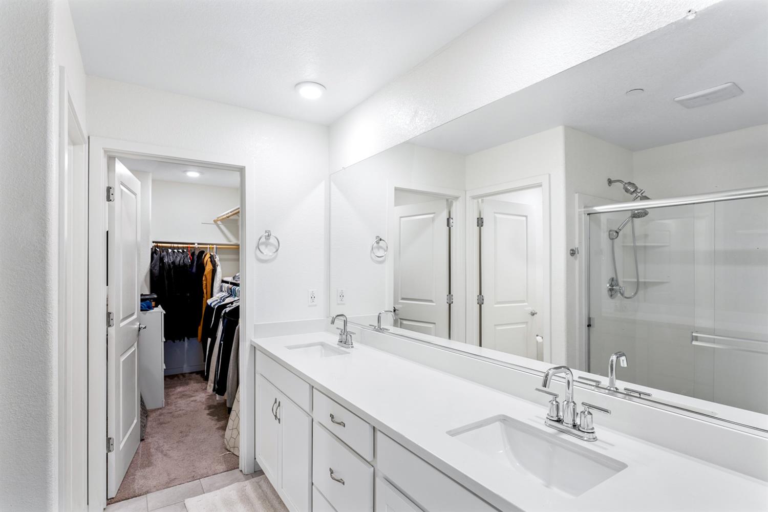 4174 Sally Ride Way Sacramento, CA 95834 - Photo 30 of 38 a bathroom with a double vanity sink mirror and shower
