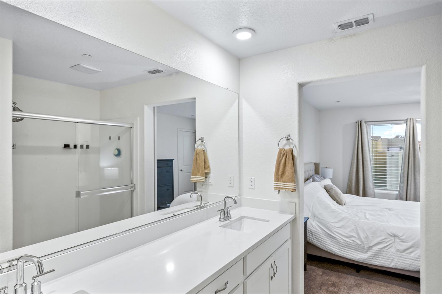 4174 Sally Ride Way Sacramento, CA 95834 - Photo 32 of 38 a en suite bathroom with a double sink and mirror