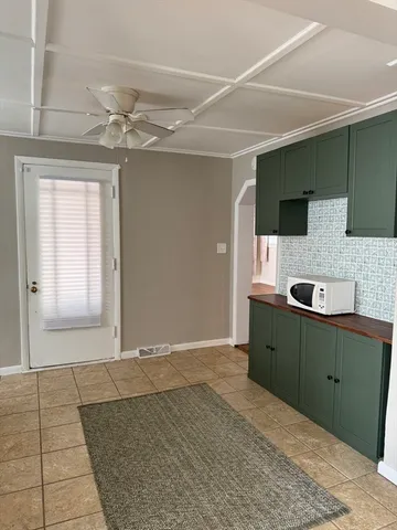 a spacious bathroom with a mirror and a sink
