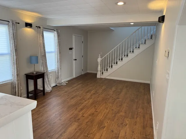 a view of an entryway with wooden floor