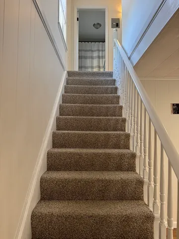 a view of staircase with white walls