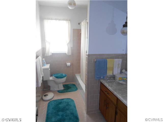 10315 Oakton Road Chesterfield, VA 23838 - Photo 8 of 8 a bathroom with a granite countertop toilet a sink and a mirror