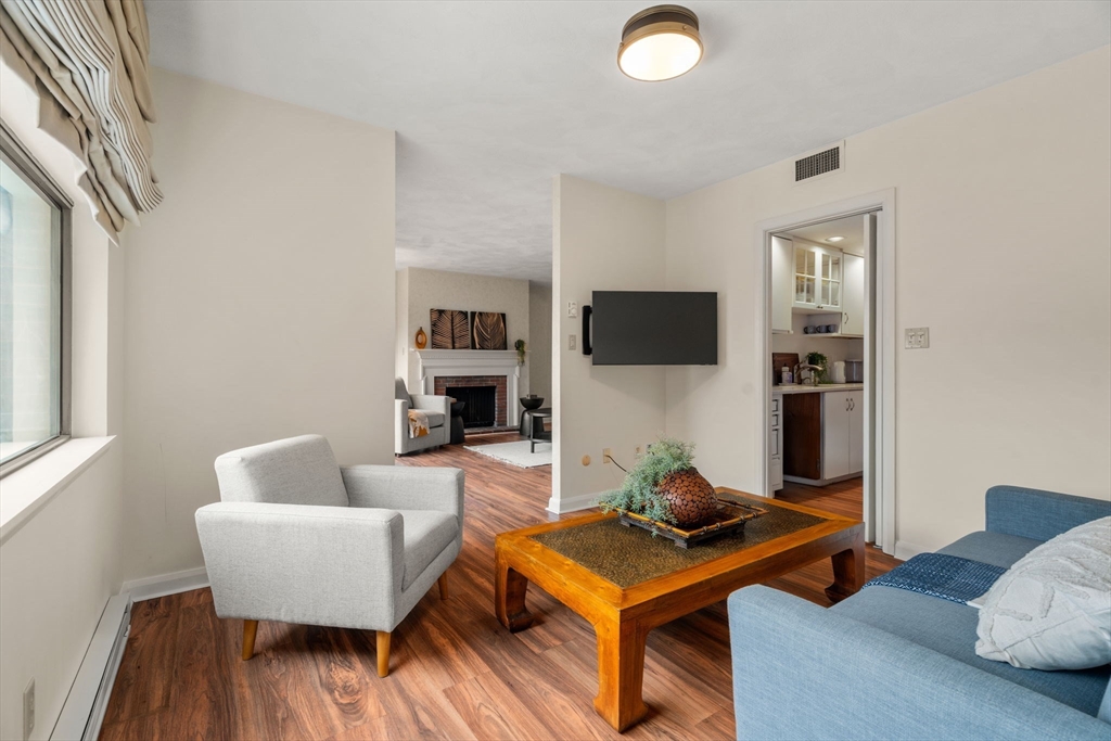 75 Grove Street, Unit 227 Wellesley, MA 02482 - Photo 9 of 29 a living room with furniture and a flat screen tv