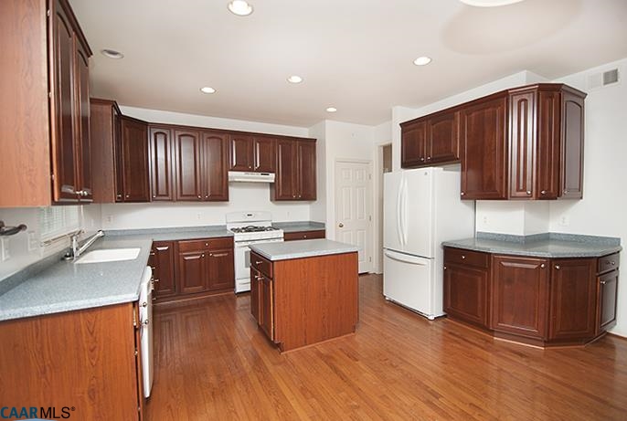 702 Rainier Road Charlottesville, VA 22903 - Photo 6 of 27 a kitchen with stainless steel appliances granite countertop wooden cabinets a stove a sink and dishwasher with wooden floor