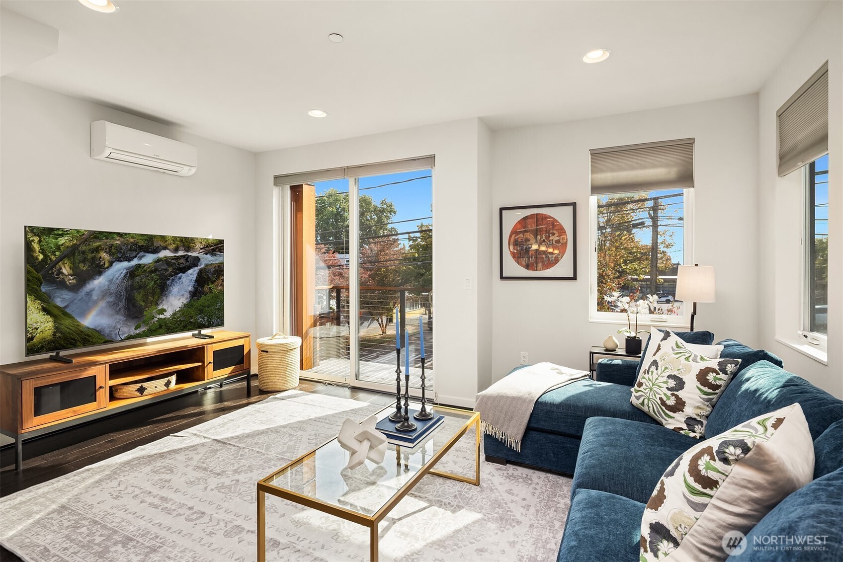 3300 Northeast 65th Street, Unit 211 Seattle, WA 98115 - Photo 5 of 15 a living room with furniture and a flat screen tv