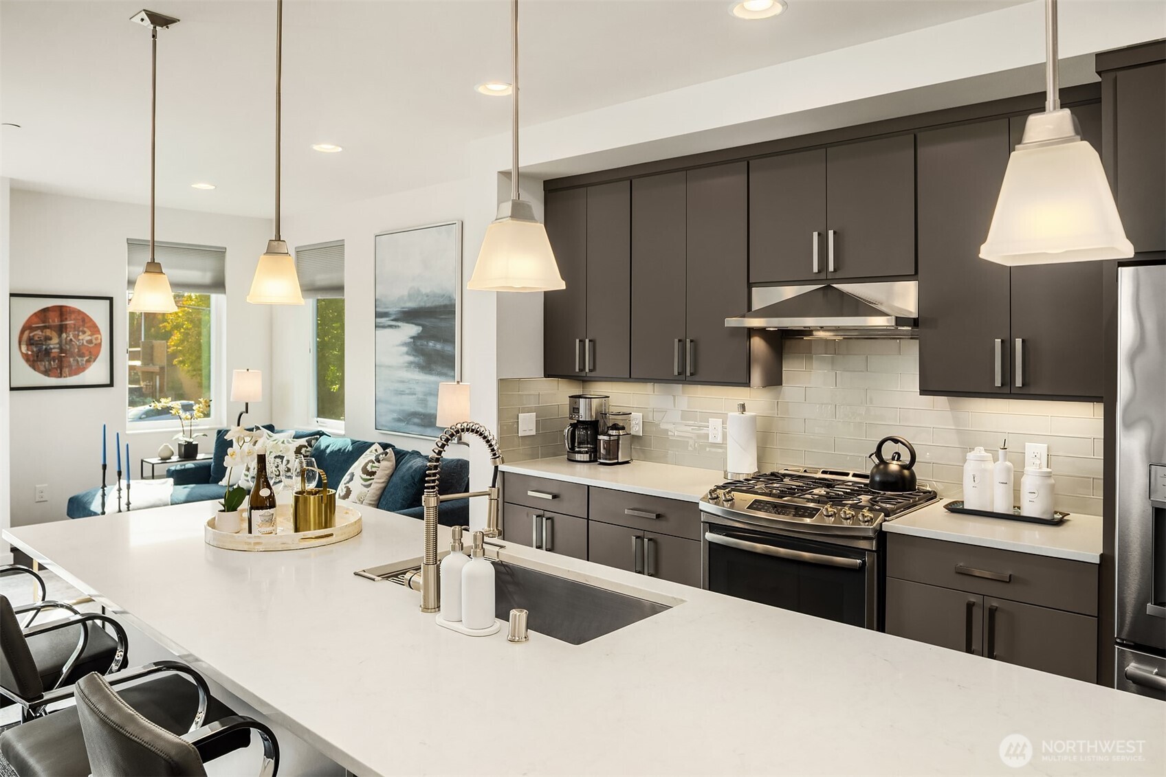 3300 Northeast 65th Street, Unit 211 Seattle, WA 98115 - Photo 8 of 15 a kitchen with stainless steel appliances a sink a stove a kitchen island with wooden cabinets and floor