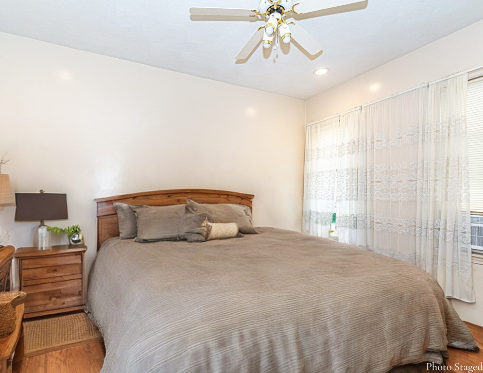 98 Margin Street Salem, MA 01970 - Photo 10 of 17 a bedroom with a bed and a chandelier