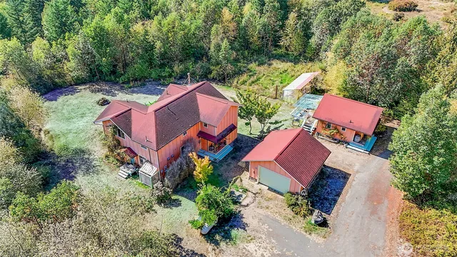 an aerial view of a house with a yard and trees