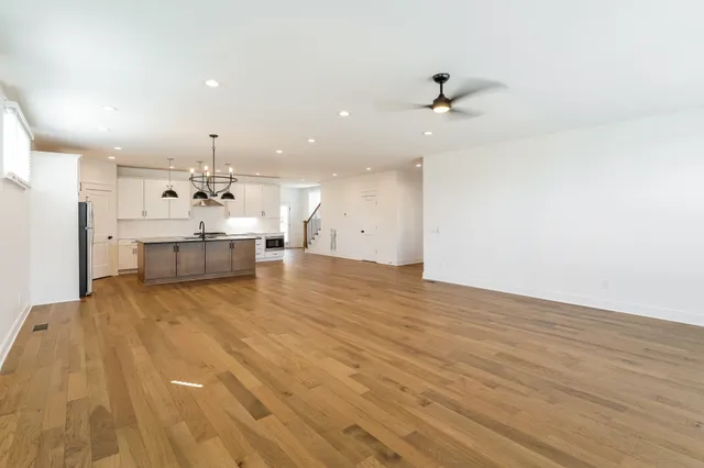 a view of a kitchen with a sink and wooden floor