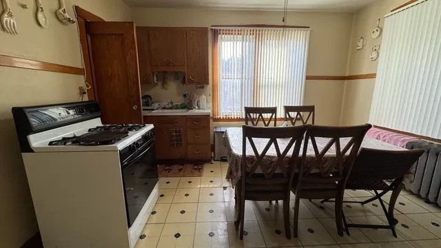 a kitchen with a table chairs and a window