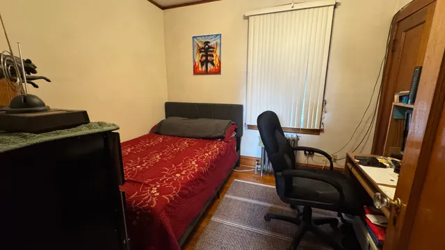 a bedroom with furniture and a window