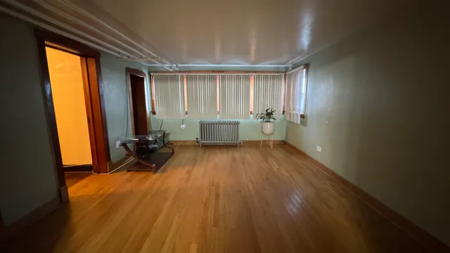 a room with wooden floor and furniture
