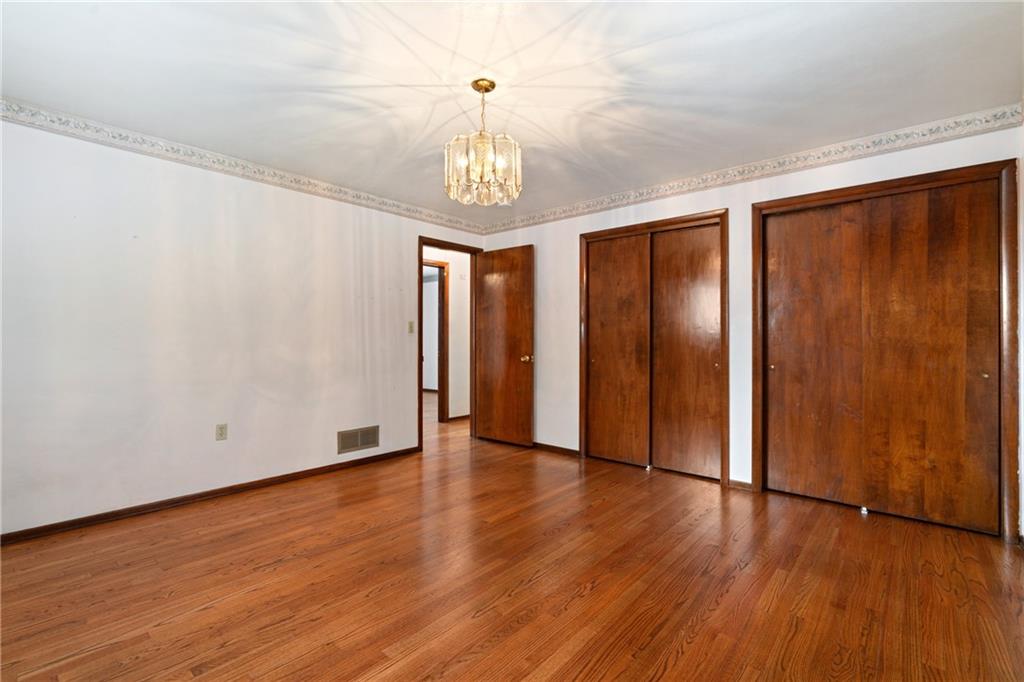 735 Harrison City Road Trafford, PA 15085 - Photo 18 of 36 Primary bedroom had pristine hardwood floors, with 2 spacious closets.