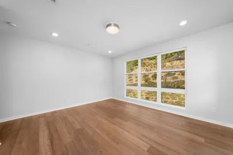 a view of an empty room and a window