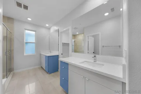 a bathroom with a granite countertop toilet a sink and a bathtub