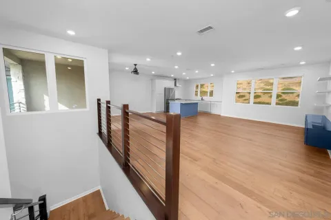 a living room with lots of furniture and a large window