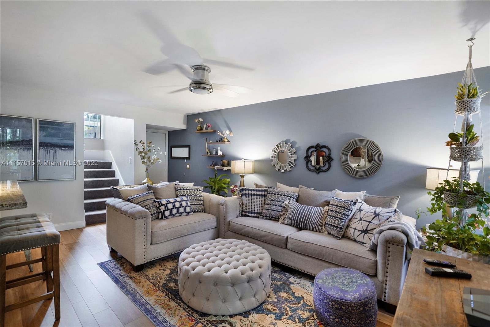 1089 Northwest 13th Street, Unit 6 Boca Raton, FL 33486 - Photo 3 of 32 a living room with furniture and a wooden floor