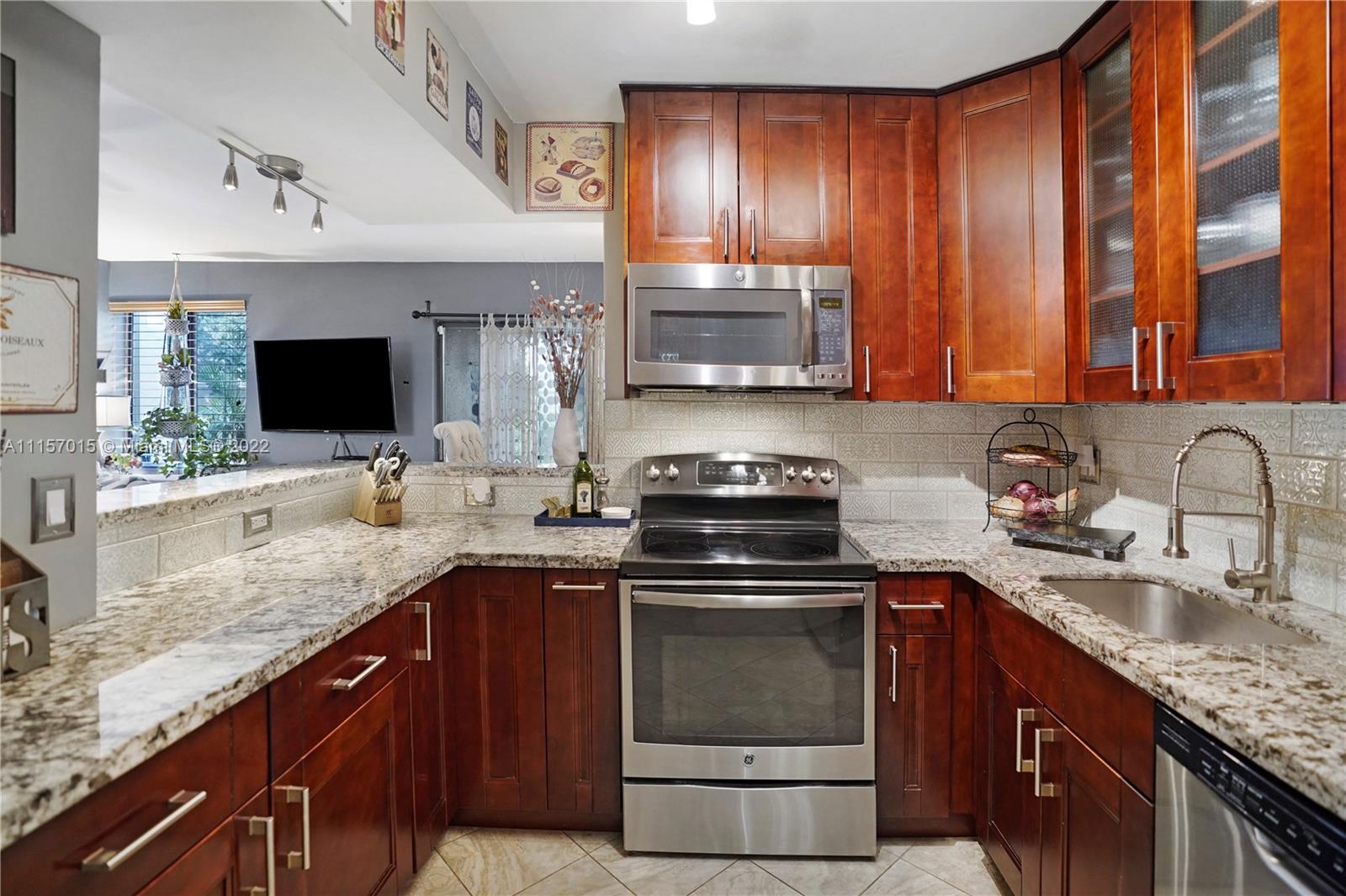 1089 Northwest 13th Street, Unit 6 Boca Raton, FL 33486 - Photo 4 of 32 a kitchen with a sink stove and microwave