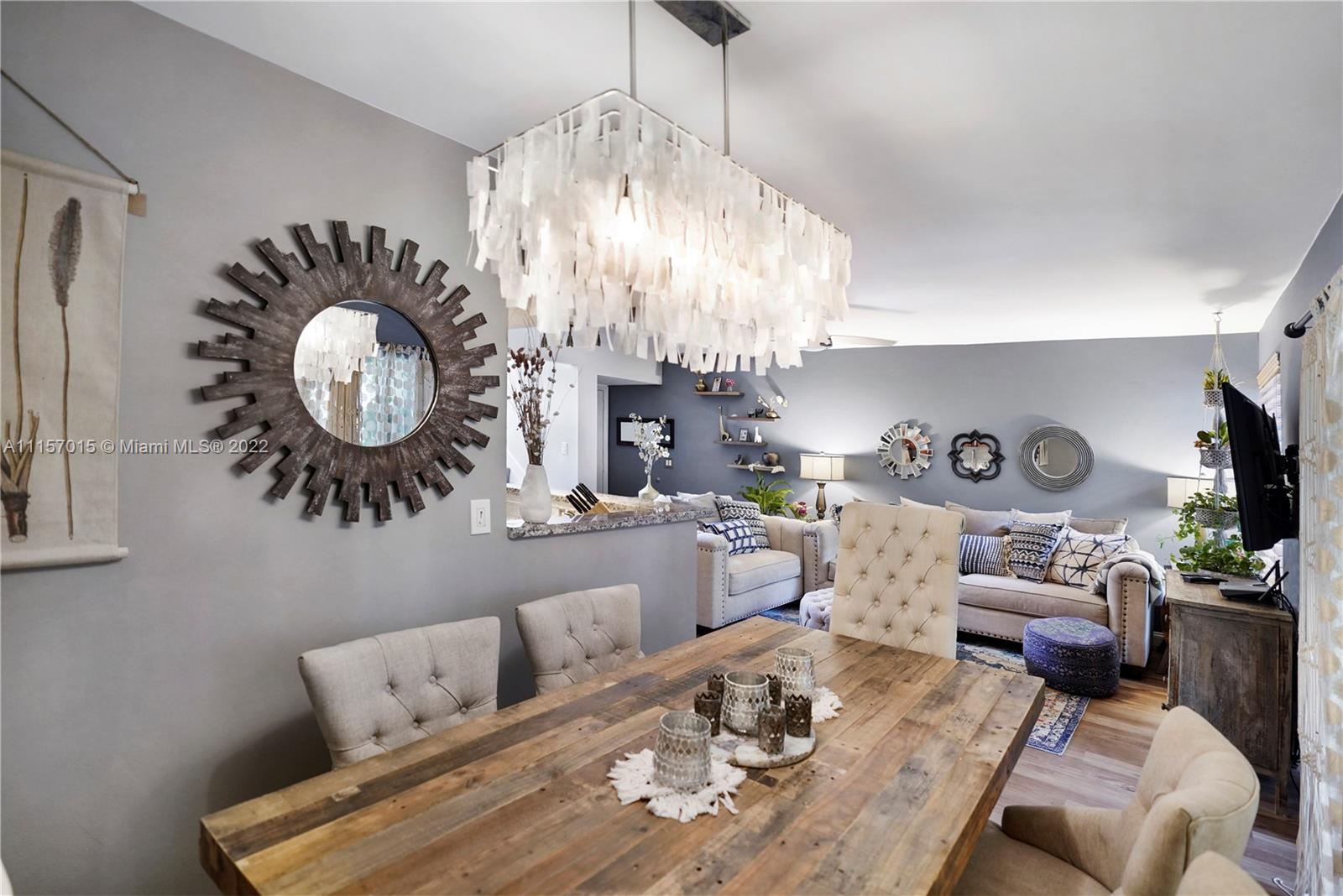 1089 Northwest 13th Street, Unit 6 Boca Raton, FL 33486 - Photo 5 of 32 a living room with furniture and a chandelier