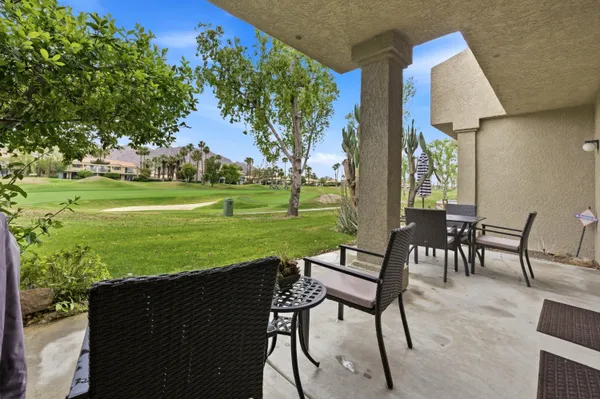 a view of a chairs and table on the patio