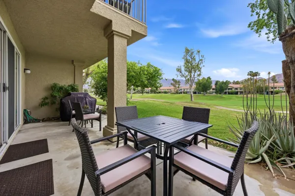 a view of a patio with a table chairs and a table