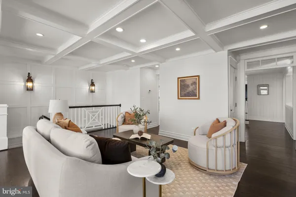 a dining room with wooden floor a chandelier a wooden table and chairs