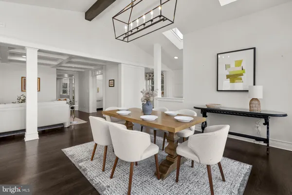 a view of a dining room with furniture a chandelier and wooden floor