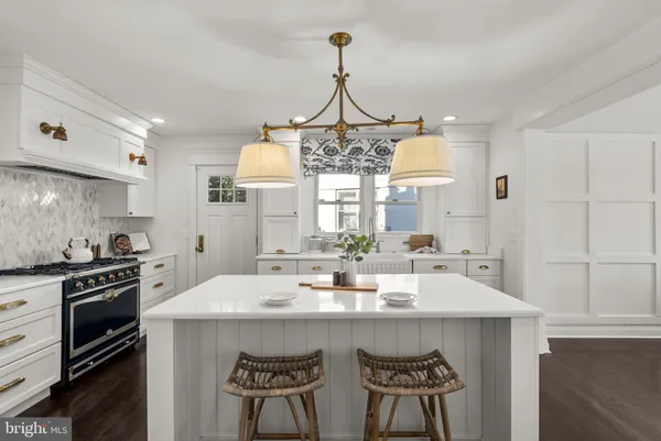 a kitchen with a stove a sink and a refrigerator