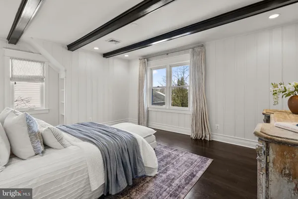 a bedroom with a large bed and a window